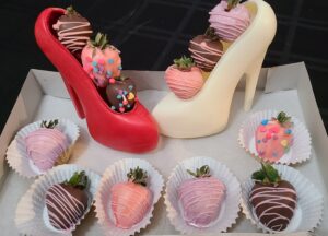 Red and white chocolate high heels with decorated strawberries