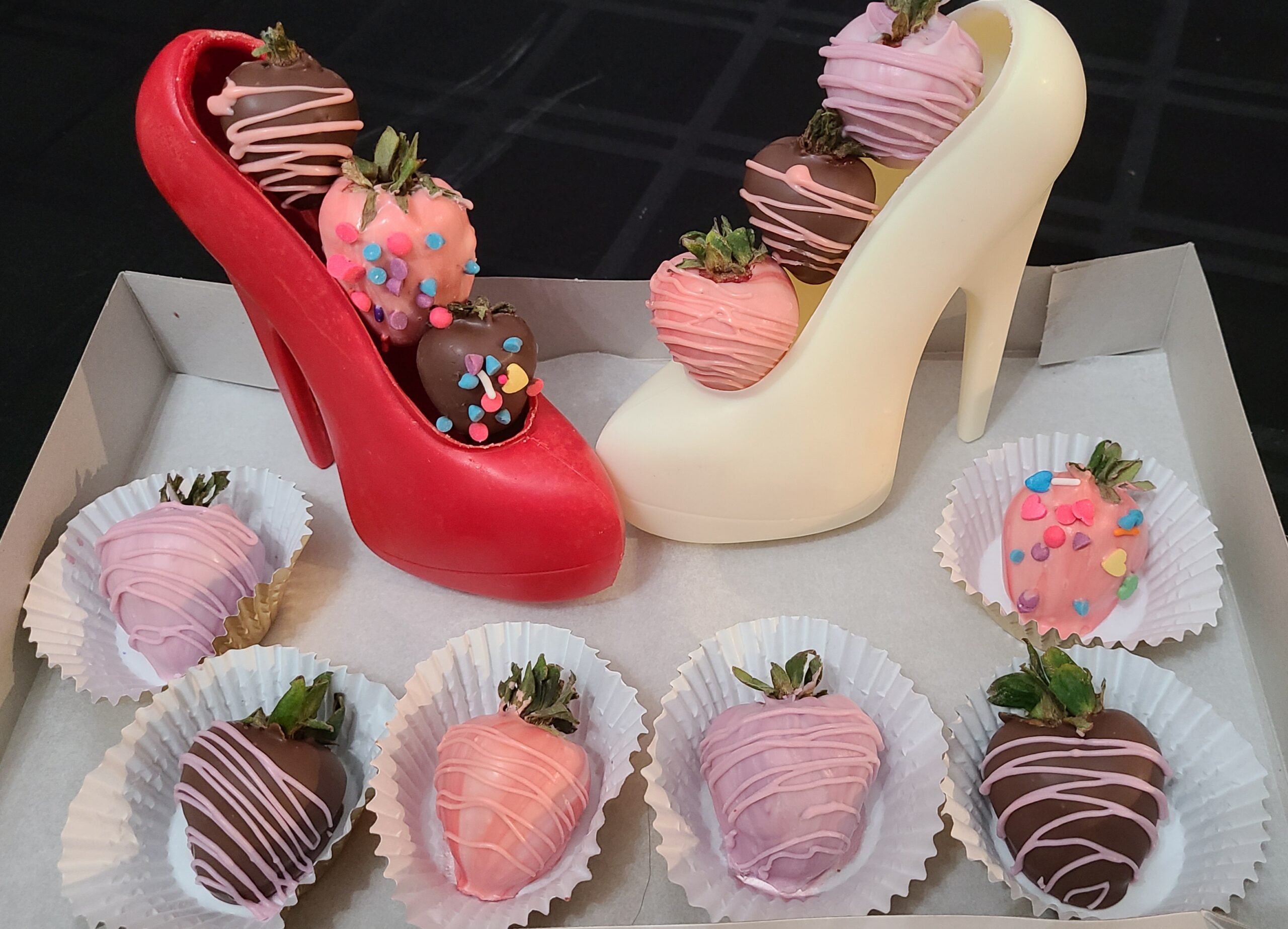 Red and white chocolate high heels with decorated strawberries