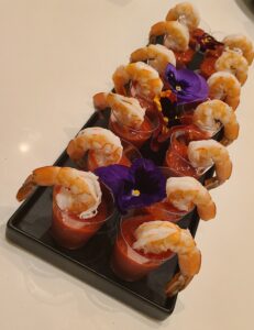 Bite sized shrimp appetizers arranged on a serving board