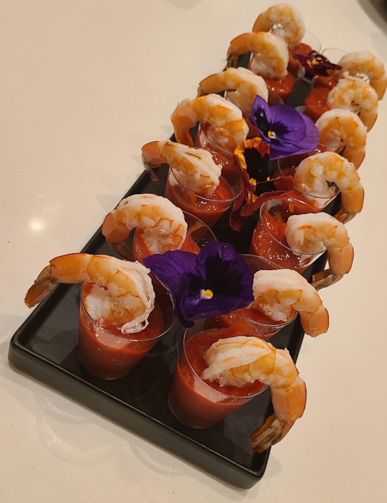 Bite sized shrimp appetizers arranged on a serving board