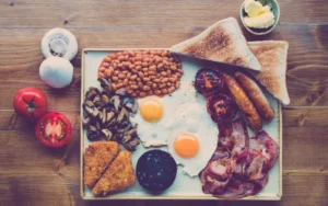 Breakfast platter with eggs, bacon, sausage, toast and beans